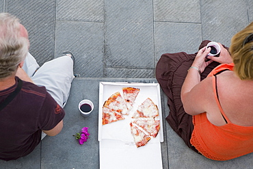 High angle view of two people having pizza, Italian Riviera, Genoa, Liguria, Italy