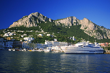 Cruise ship on a harbor in front of buildings, Capri, Italy