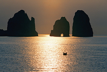 Silhouette of cliffs in the sea during sunrise, Capri, Italy