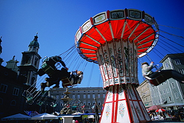 Low angle view of a chain swing ride at a carnival, Salzburg, Austria