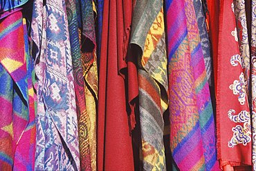 Close-up of shawls hanging in a store