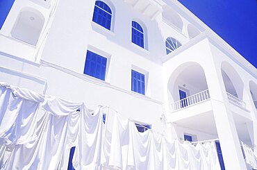 Cloths drying on a clothesline in front of a building