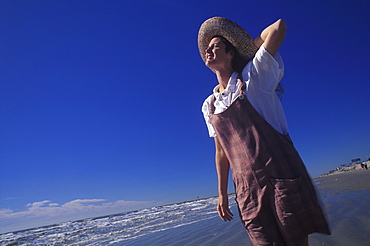 Low angle view of a young woman standing on the beach, Texas, USA