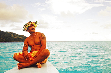 Close-up of a young man sitting on a ship's bow, Hawaii, USA