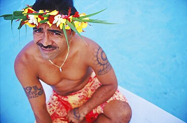 High angle view of a young man sitting on a ship's bow, Hawaii, USA