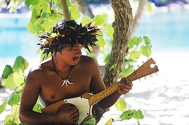 Close-up of a young man playing the ukulele, Hawaii, USA