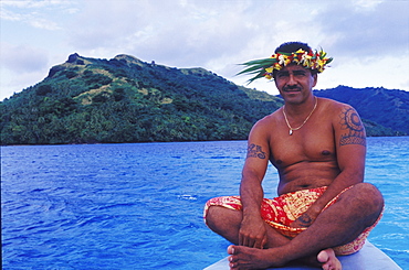 Close-up of a young man sitting on a ship's bow, Hawaii, USA