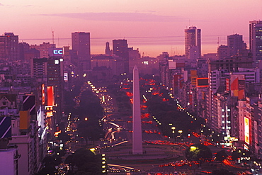 High angle view of buildings lit up at dusk