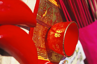 Close-up of a bowl and incense sticks on a mat