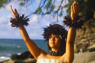 Close-up of a hula dancer with her arms raised, Hawaii, USA