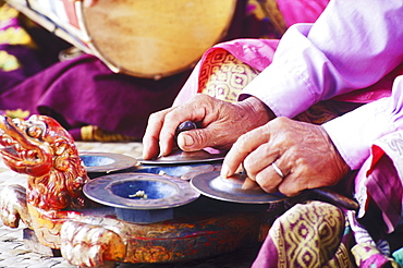 Mid section view of a person playing cymbals, Bali, Indonesia