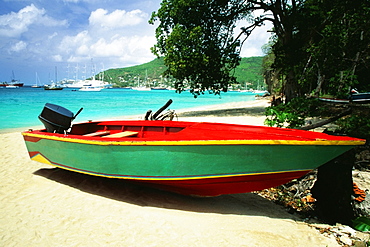 A boat is seen on a seashore on a sunny day, The Grenadines