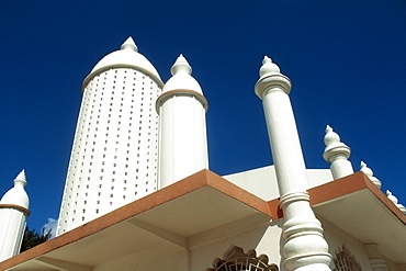 A prominent minaret of a Hindu temple is seen against the blue sky, Trinidad, Caribbean