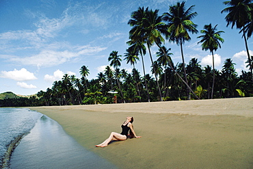 A woman relaxing on a beach, Puerto Rico