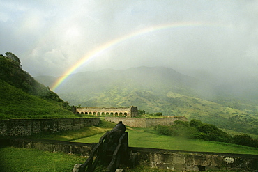 View of a beautiful rainbow arched amidst vast and lush meadows, St. Kitts, Leeward Islands, Caribbean