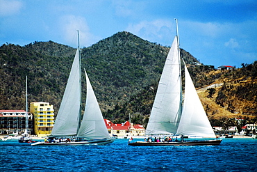 Two sailboats are seen participating in the Heiniken Regatta on the Dutch side of the island of St. Maarten in the Caribbean