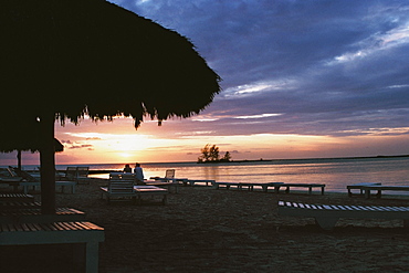 Silhouette of a thatched canopy is seen at Negril Beach, Jamaica