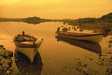 Reflection of boats in a lake, Ross lake, County Galway, Republic of Ireland