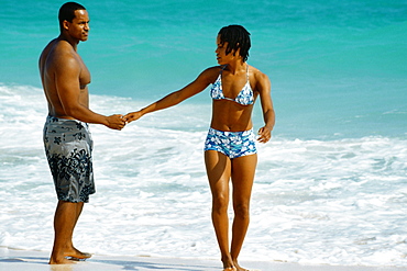 A couple in swimsuit enjoying on Horse-shoe Bay beach, Bermuda