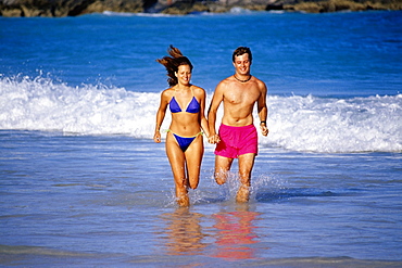 A couple running through the seawater, Horse-shoe Bay beach, Bermuda