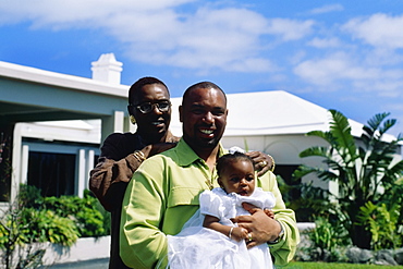 Front view of a couple holding their baby girl, Bermuda