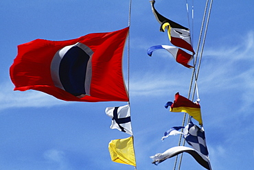 Low angle view of colorful flags against the sky on a sunny day, Crystal palace hotel, Nassau, Bahamas