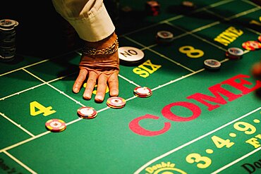 High angle view of a man's hand on a gaming table in a casino, Las Vegas, Nevada, USA