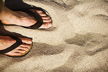 Close-up of human feet wearing sandals