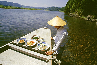 Mature man standing near a boat, Shimanto River, Kochi, Shikoku, Japan