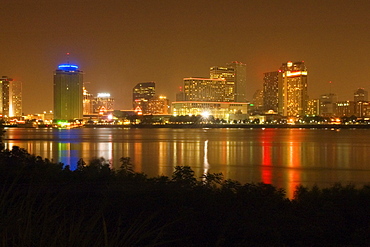 Buildings in a city lit up at night, New Orleans, Louisiana, USA