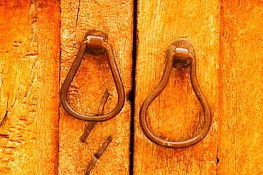 Close-up of a pair of doorknockers on a door