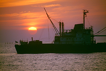 Freighter at sunset in Ho Chi Minh City (formerly Saigon) Vietnam