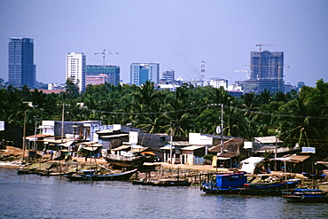 Saigon River contrasts with hi-rises in background, Vietnam