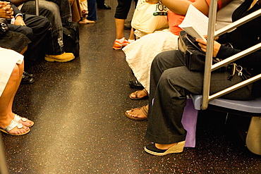 Passengers sitting in a subway train