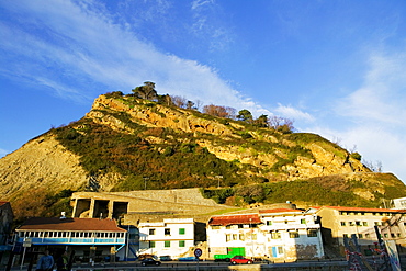 Low angle view of buildings at the foot of a hill, Spain