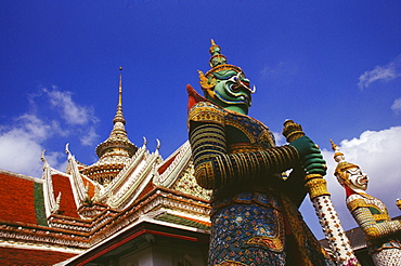 Low angle view of statues in front of a temple, Wat Arun, Bangkok, Thailand