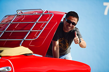 Mid adult man standing behind a convertible car, Miami, Florida, USA