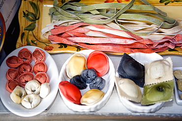 Close-up of uncooked assorted pastas and dumplings in trays