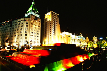 Buildings and fountains lit up at night, The Bund, Shanghai, China