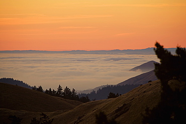 High angle view of clouds around a hill