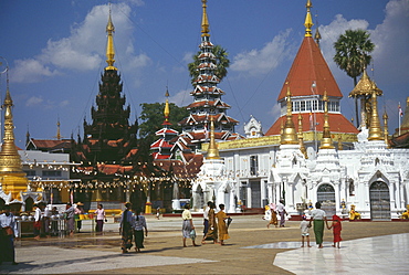 Pilgrims walking in front of a pagoda, Shwedagon Pagoda, Yangon, Myanmar