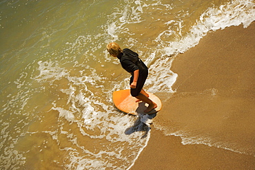 High angle view of a boogie boarder on the beach