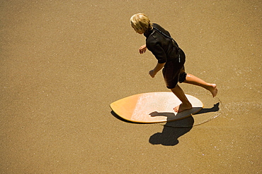 High angle view of a boogie boarder on the beach