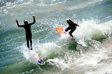 High angle view of two boogie boarders on the beach