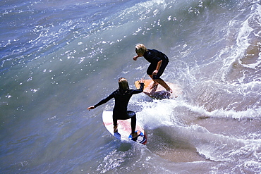 High angle view of two boogie boarders on the beach