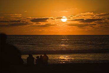 Silhouette of people on the beach at dusk, San Diego, California, USA