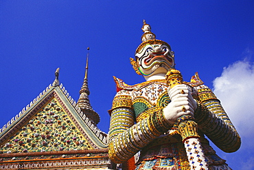 Low angle view of a statue of demon in front of a temple, Wat Arun, Bangkok, Thailand