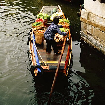 High angle view of a man rowing a rowboat in a canal, Zhouzhuang, Kunshan City, Jiangsu Province, China