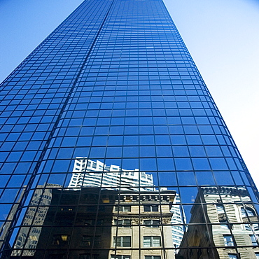 Low angle view of the reflection of buildings on a glass front, John Hancock tower, Boston, Massachusetts, USA