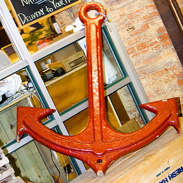 Close-up of an anchor leaning against a window